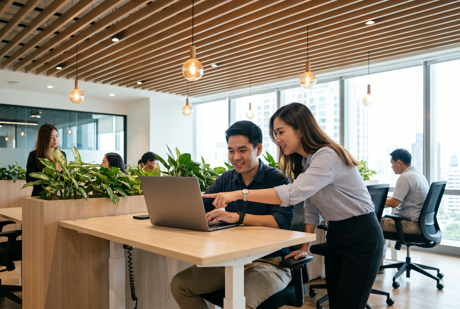 A recruiter and a colleague reviewing applicants together in a Bangkok office